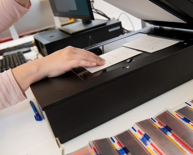 A person scanning photos and film negatives